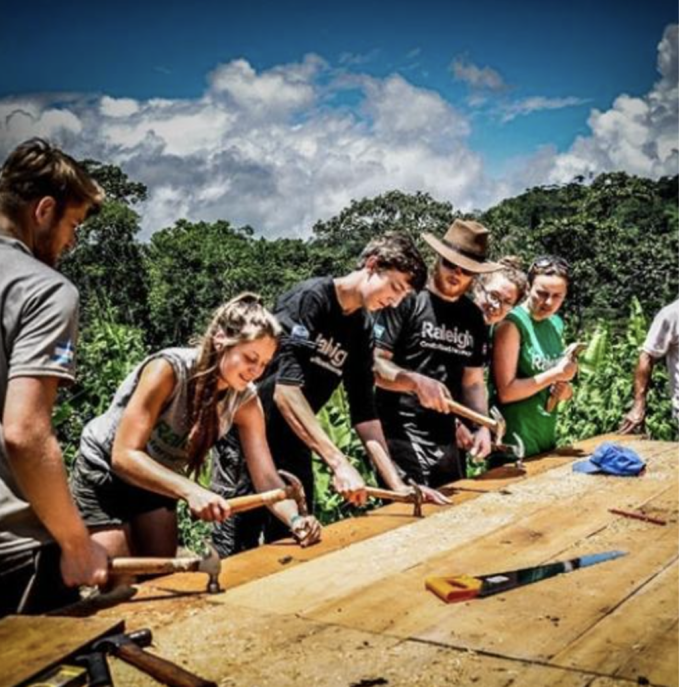 Students and volunteers collaborating on a hands-on building project outdoors